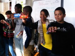 kids holding out candy bars