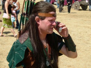 A medieval re-enactor talks on his cell phone